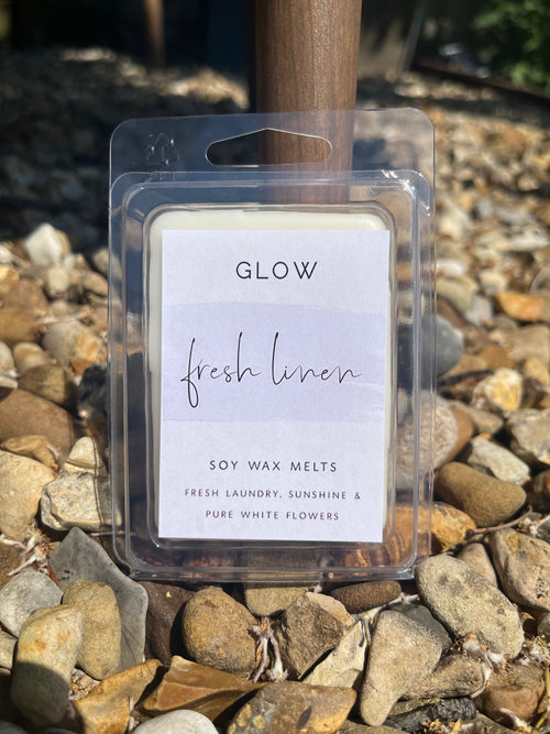 <img src="Fresh Linen Clamshell" alt="Package of GLOW wax melts labelled 'Fresh Linen' with six white rectangular melts.">